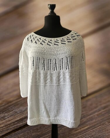 Weiße gestrickte Damen-Tunika mit Ajourmuster auf Schneiderpuppe