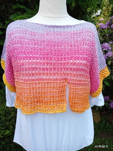 Gehäkelter Bolero mit Farbverlauf Lila–Pink–Orange auf Schaufensterpuppe