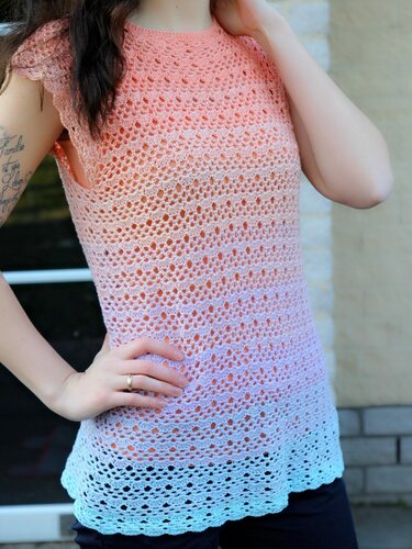 Sleeveless crocheted tunic top with a peach-to-light-blue ombre and open lace stitch pattern.