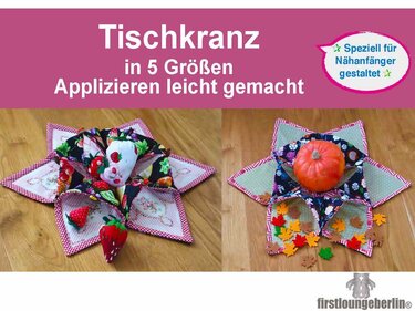 Zwei genähte Stofftischkränze mit Stofferdbeeren und einem kleinen Kürbis auf Holztisch.