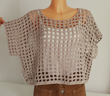 Beige open square mesh crochet tunic layered over a white camisole on a mannequin