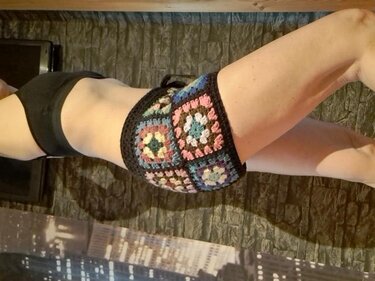 Woman wearing crocheted granny square shorts