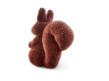 Brown crocheted squirrel amigurumi with a large curled bushy tail on a white background.