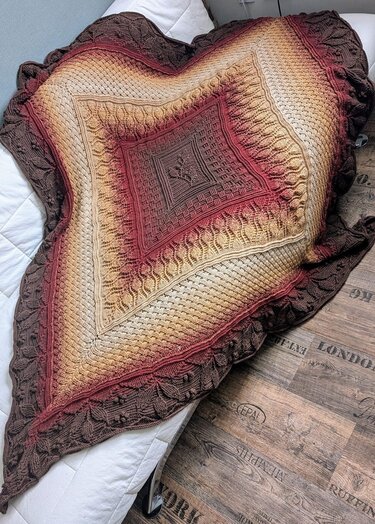 Ombré crocheted blanket with central square motif and leaf border in brown, rust and beige