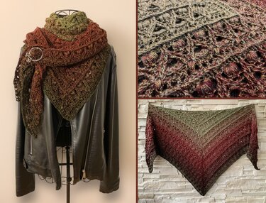 Olive to reddish-brown gradient triangle crochet shawl with subtle metallic sparkle, draped on a mannequin over a black jacket and pinned.