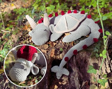 Gray crocheted amigurumi dragon with red pom-pom spines lying on a tree stump; inset shows the dragon wearing a red hat