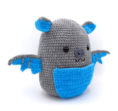 Grau-blaues gehäkeltes Amigurumi in Fledermausform mit runden schwarzen Augen