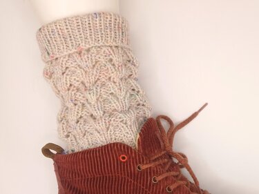 Beige gestrickte Beinstulpen mit Zopfmuster und bunten Sprenkeln zu braunen Cordstiefeln