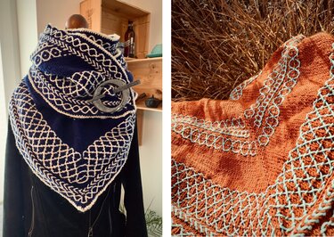Two triangle shawls: navy blue with white geometric stitchwork on a mannequin, and rust orange with light-blue stitch accents on grass.