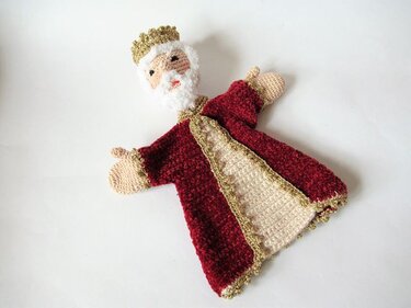 Gehäkelte Handpuppe König mit rotem Mantel, goldener Krone und weißem Bart auf hellem Hintergrund.