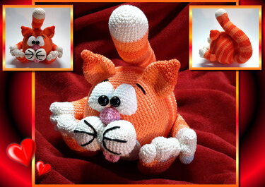 Gehäkelte orange-weiß gestreifte Amigurumi-Katze mit großen schwarzen Knopfaugen auf rotem Stoff
