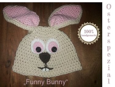 Beigefarbene gehäkelte Kindermütze im Hasendesign mit rosa Ohren und Knopfaugen
