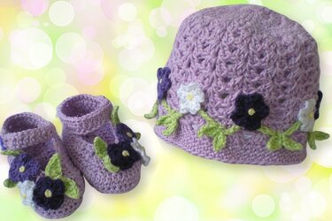 Gehäkelte Babymütze und Schühchen in Lila mit Häkelblüten