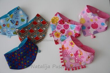 Six bandana-style baby scarves showing snap closures and one pom-pom trim