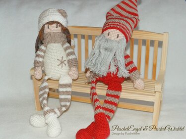 Gehäkelter Engel und gehäkelter Wichtel auf einer kleinen Holzbank