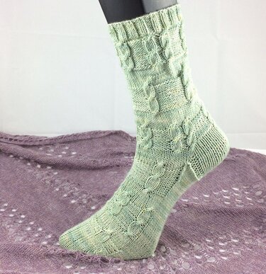 Detailaufnahme mintgrüner Zopfmustersocke mit Rippenbund