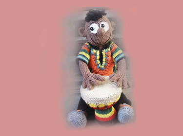 Amigurumi reference: crochet doll seated with round drum and striped details