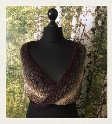 Neutral gradient openwork crochet cowl twisted at front on black mannequin