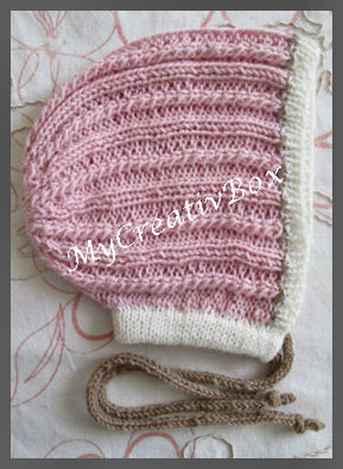 Detailansicht rosa Babymütze mit Rippenmuster, Umschlag und Bindebändern