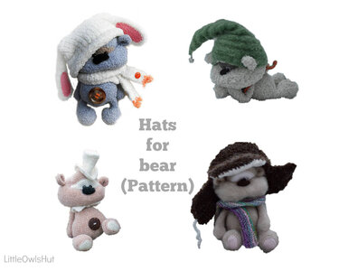 Four small knitted toy bears, each wearing a unique knit hat: a white bunny hat, a green elf hat, a tiny white top hat, and a brown aviator hat with a striped scarf.