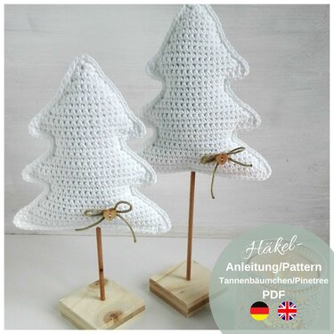 Small freestanding crochet pine trees on wooden sticks and square bases with button bows