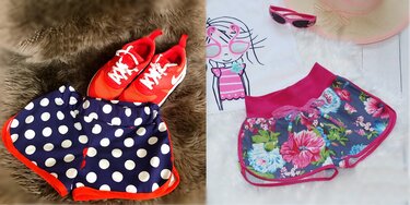 Detailaufnahme: zwei Kinder-Shorts im Vergleich - florale Short mit breitem Bund und Kordel, gepunktete Short mit elastischem Bund und roter Einfassung