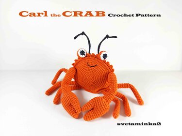 Bright orange crocheted amigurumi crab with spiral body, separate claws, and eye stalks on white background