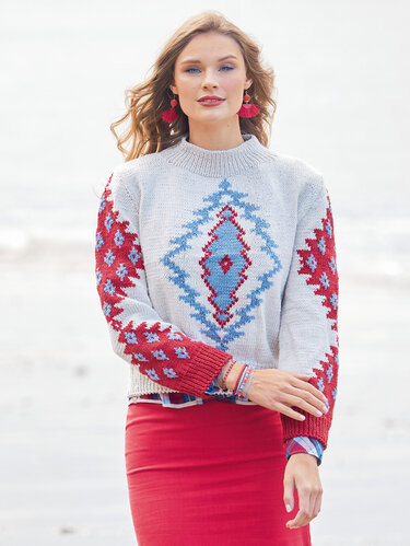 Naturfarbener Pulli mit grafischen Intarsien in Hellblau und Rot