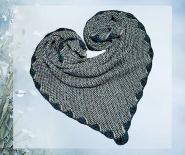 Grey and dark teal crochet triangle shawl folded into a heart showing scalloped edge and textured stitch.