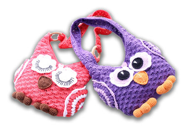 Front view of pink and purple crocheted owl handle bags showing eye appliques, beaks, feet, crocheted straps and wooden ring handles.