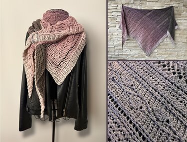 Crochet triangle shawl in pink-to-grey gradient with lace and textured stitch panels draped over a black jacket and secured with a shawl pin.