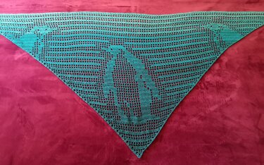 Petrolfarbenes gehäkeltes Dreieckstuch mit Delfin-Motiv auf pinkem Untergrund