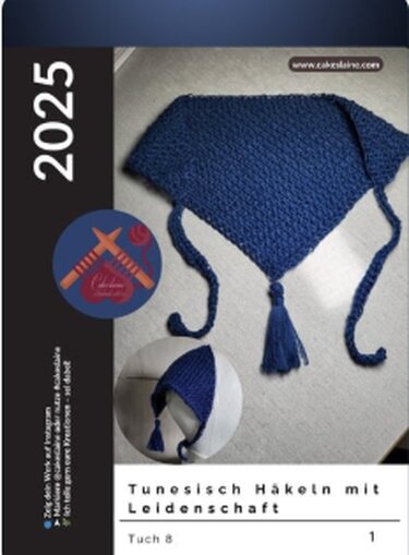 Blue triangular Tunisian crochet shawl with tassel and long ties on a light surface