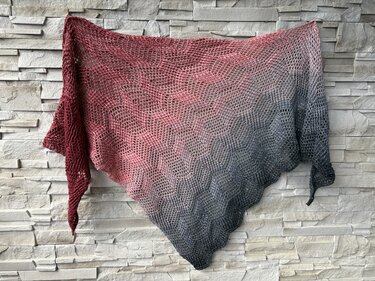 Ombre triangle crochet shawl in red, pink and gray with geometric openwork