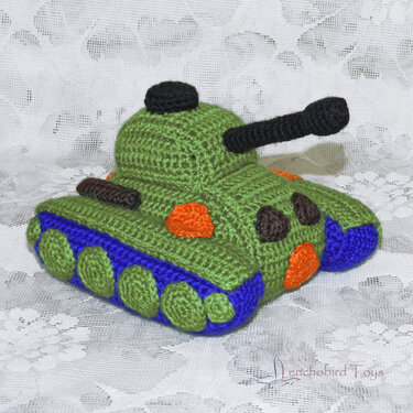 Hand-crocheted green tank amigurumi with blue tracks and black barrel