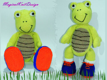 Two hand-knitted lime-green amigurumi turtles, one seated with orange-and-blue booties and one standing with blue shoes and orange laces.