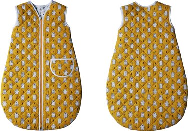 Front and back views of a quilted mustard-yellow sleeveless baby sleeping bag with white bear print, center zipper and piped front pocket