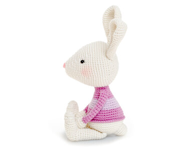 Cream crocheted amigurumi rabbit wearing a pink-striped sweater, side profile