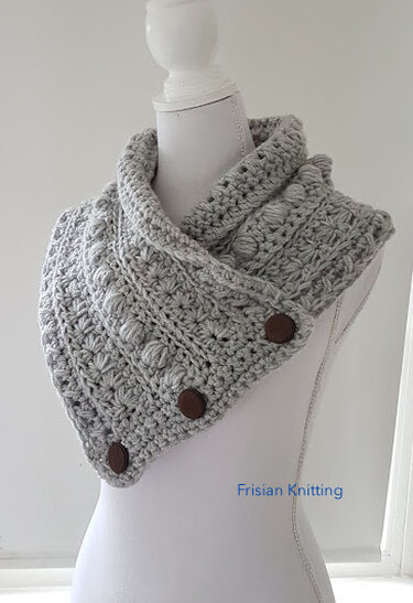 Light gray chunky crochet collar scarf with three dark buttons on a white mannequin