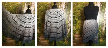 Ombre crescent crochet shawl in gray-to-blue ombre with lace stitch detail, displayed on a black mannequin.