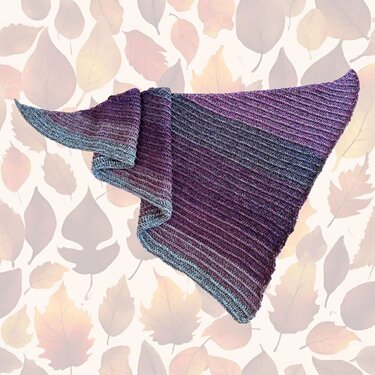 Triangular crocheted shawl with purple-to-gray gradient and diagonal ribbed texture