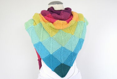Gestricktes Dreieckstuch in Regenbogenfarben aus kraus-rechten Dreiecksquadraten auf Schaufensterpuppe