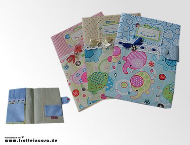 Drei genähte Utensilo‑Stoffhüllen mit Elefanten- und Herzmotiven, eine geöffnet mit Innenfächern