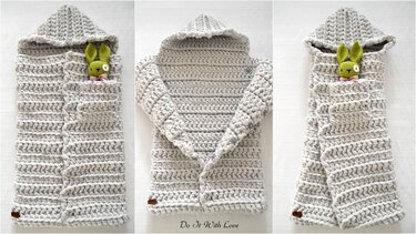 Light grey crocheted baby cocoon with hood and side button closure, a small green crocheted rabbit peeking from the opening.