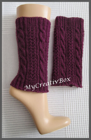 Dunkelviolette gestrickte Beinstulpen mit Zopfmuster auf einem Mannequinbein