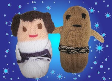 Zwei gestrickte Amigurumi-Puppen: weiße Puppe mit dunklem Haar und braune Puppe mit Taillenband vor sternenblauem Hintergrund