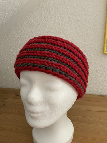Gestricktes rotes Stirnband mit grauen Streifen auf weißem Kopfmodell