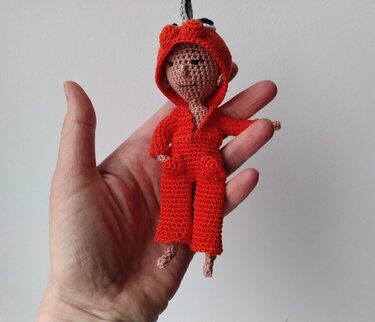 Doll with chainsaw and eyes on her hoodie, crochet amigurumi