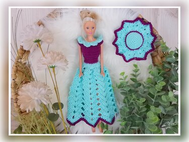 Doll in purple and light blue crocheted dress with matching round accessory