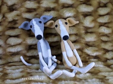 Image of two crocheted dogs highlighting long limbs, tapered snouts, folded ears, and stitch texture